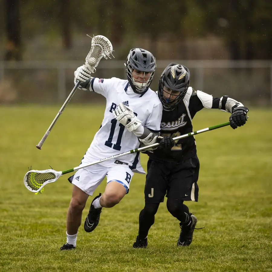 A boys player dodges past a defender