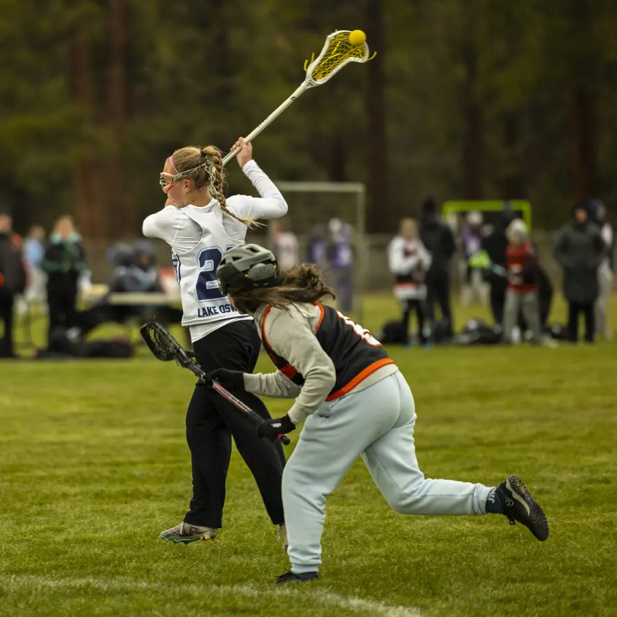 A girls player winds up to shoot as a defender closes in