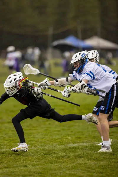 A defender lunges to check a ball carrier